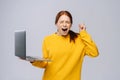 Successful happy shocked young woman with closed eyes holding laptop computer Royalty Free Stock Photo