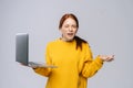 Successful happy shocked young woman with closed eyes holding laptop computer Royalty Free Stock Photo