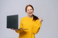 Successful happy shocked young woman with closed eyes holding laptop computer Royalty Free Stock Photo