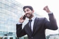 Successful businessman or worker in suit with phone near office building Royalty Free Stock Photo