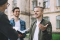 Successful happy students standing near campus or university outside Royalty Free Stock Photo