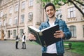 Successful happy students standing near campus or university outside Royalty Free Stock Photo