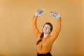 A successful and happy woman throws money up for joy