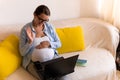 Successful hardworking Pregnant business Woman With Laptop and Noutbook. Young Ledy In Pregnancy Work conducts an online