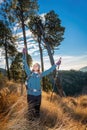 successful hiker observing on mountain peak cliff edge