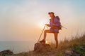 Successful Hiker women hiking with backpack standing on top of the mountain and enjoying valley view Royalty Free Stock Photo