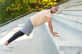 Successful hispanic sportsman doing various physical exercises, morning workout at the stadium, man motivationally