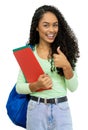 Successful hispanic student with dental aligner and books and backpack Royalty Free Stock Photo