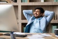 Successful indian business guy resting relaxing in comfortable office chair Royalty Free Stock Photo