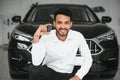 Successful indian businessman in a car dealership - sale of vehicles to customers. Royalty Free Stock Photo