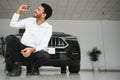 Successful indian businessman in a car dealership - sale of vehicles to customers. Royalty Free Stock Photo