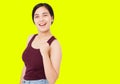 Successful korean,asian woman isolated on yellow background,girl show gesture of success positive sign thumbs yes