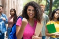 Successful latin american female student with group of caucasian and african american young adults Royalty Free Stock Photo