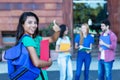 Successful latin american female student with group of students Royalty Free Stock Photo