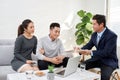 Successful lawyer giving consultation to family couple about buying house Royalty Free Stock Photo