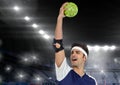 Successful male athlete holding ball in stadium Royalty Free Stock Photo