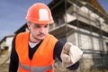 Successful male builder using an imaginary screen Royalty Free Stock Photo