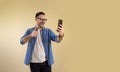 Successful male businessman entrepreneur showing thumbs up sign while talking over video call on smart phone. Young man cheerfully Royalty Free Stock Photo