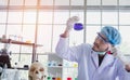 A successful male chemist is examining his new innovation in a laboratory. Royalty Free Stock Photo