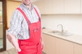 Successful male plumber doing welcoming gesture