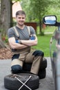 Successful man before changing car wheel Royalty Free Stock Photo