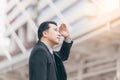 successful man entrepreneur looking up on modern skyscraper while standing outdoors, young executive male director