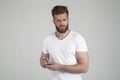 Successful man with lush ginger beard. holds the razor in his arms and looks brutally into the camera. dressed in casual clothes. Royalty Free Stock Photo