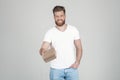 Successful man with lush ginger beard. smiling stretches a gift to the camera. box with the goods. dressed in casual clothing.