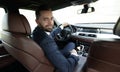 Successful man sitting behind the wheel of a prestigious car Royalty Free Stock Photo