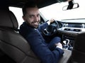 Successful man sitting behind the wheel of a prestigious car Royalty Free Stock Photo