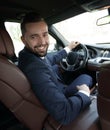 Successful man sitting behind the wheel of a prestigious car Royalty Free Stock Photo