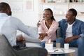 Successful Marital Therapy. Happy Black Spouses Handshaking With Family Counselor After Reconciliation Royalty Free Stock Photo