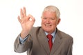 Successful mature businessman giving okay sign