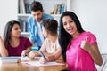 Successful mexican female student learning with group of students Royalty Free Stock Photo