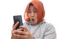 Successful muslim Asian woman surprised amazed smiling while reading message text good news on her smart phone Royalty Free Stock Photo