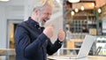 Successful Old Man Celebrating on Laptop in Cafe Royalty Free Stock Photo