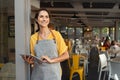 Successful owner standing at cafe entrance Royalty Free Stock Photo