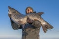 Successful pike fishing. Happy fisherman hold huge muskie fish