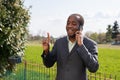 Successful positive african american businessman makes a phone call with a customer