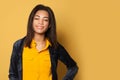 Successful positive black woman on yellow background, studio portrait