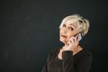 A successful positive elderly female consultant is negotiating a cell phone. Communication between people using modern Royalty Free Stock Photo