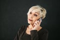 A successful positive elderly female consultant is negotiating a cell phone. Communication between people using modern Royalty Free Stock Photo