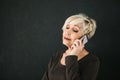 Mature beautiful positive woman talking on cell phone. Royalty Free Stock Photo