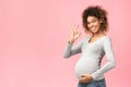 Successful pregnancy. Positive afro girl showing ok sign