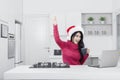 Successful pretty girl with laptop and Santa hat Royalty Free Stock Photo