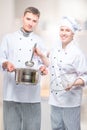 successful professional chefs with a pan and a ladle in a commercial Royalty Free Stock Photo