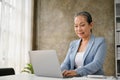 Successful senior businesswoman using laptop, working on her business project on laptop Royalty Free Stock Photo