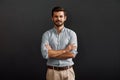 Successful project manager. Cheerful and young bearded man looking at camera with smile and keeping arms crossed while Royalty Free Stock Photo