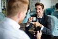 Successful project, two business people in formalwear discussing in cafe. Royalty Free Stock Photo