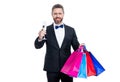 successful purchase of tuxedo man go shopping. tuxedo man with shopping bag isolated on white